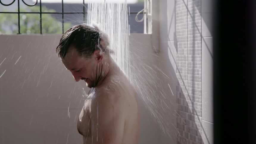 Man takes a shower on a sunny day
