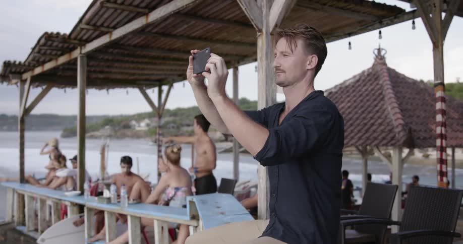 Man takes a picture of the beach