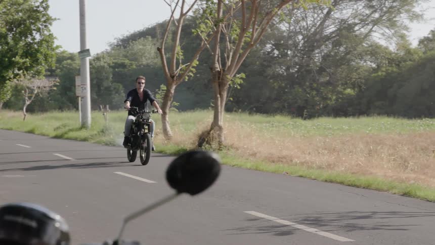 Man motorcycles on a rural road