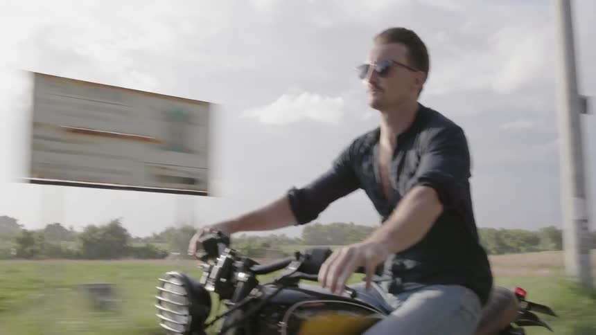 Man motorcycles on a rural road