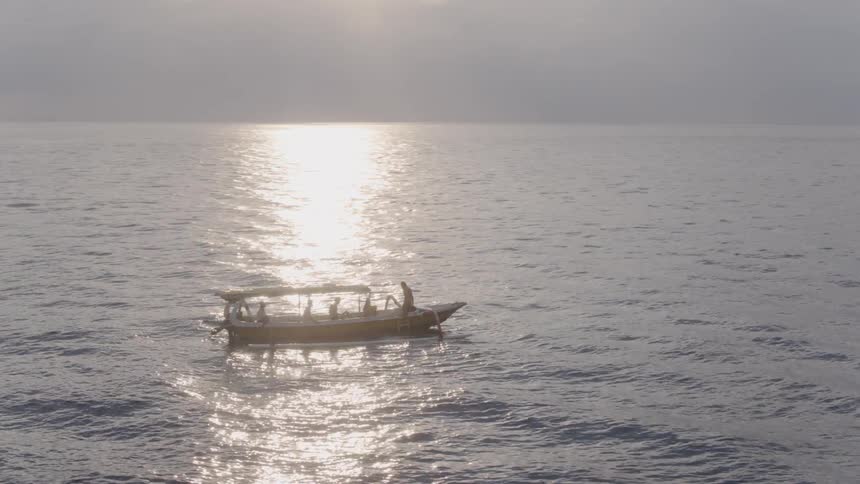 People ride on a boat on the open water