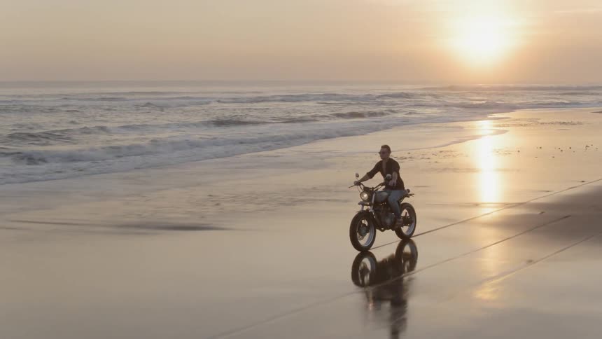 Man rides a motorcycle on the beach