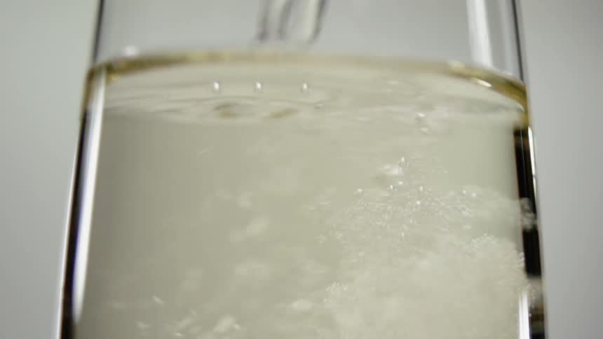Champagne is poured into a glass