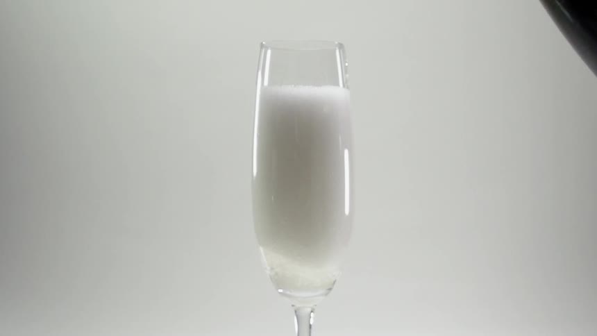 Champagne is poured into a glass
