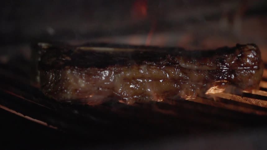A steak is cooked on a grill