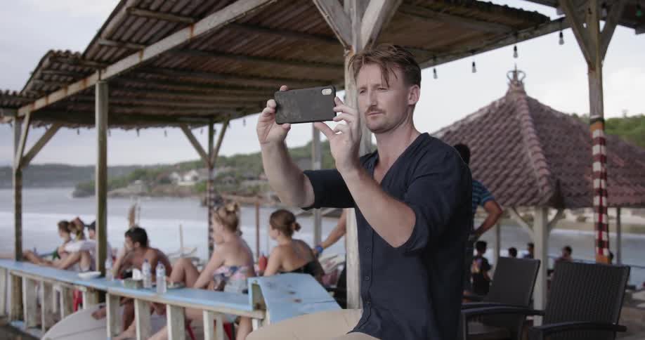 A man is taking photographs on the pier