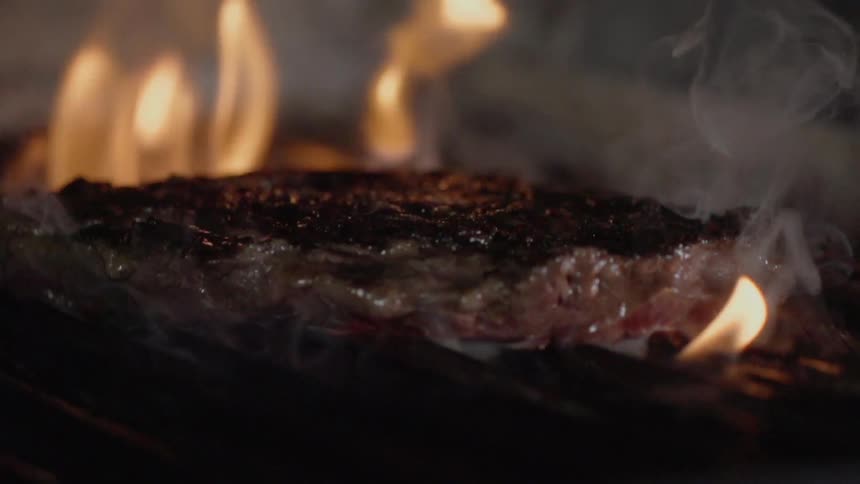 A steak is cooked on a grill