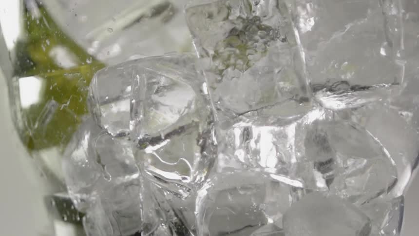 Ice cubes in a glass with garnish drip