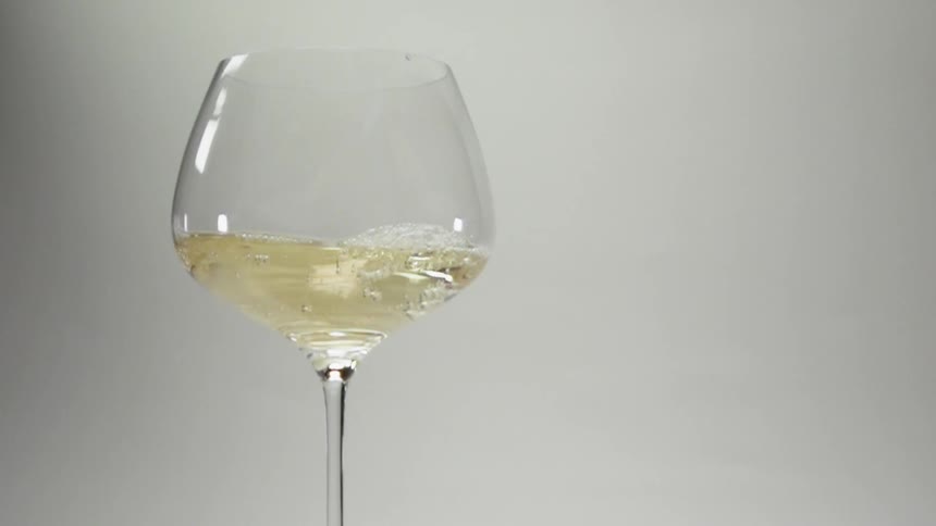 White wine swirls in a wine glass