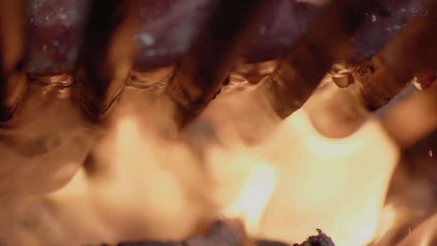 Meat cooking over a flame