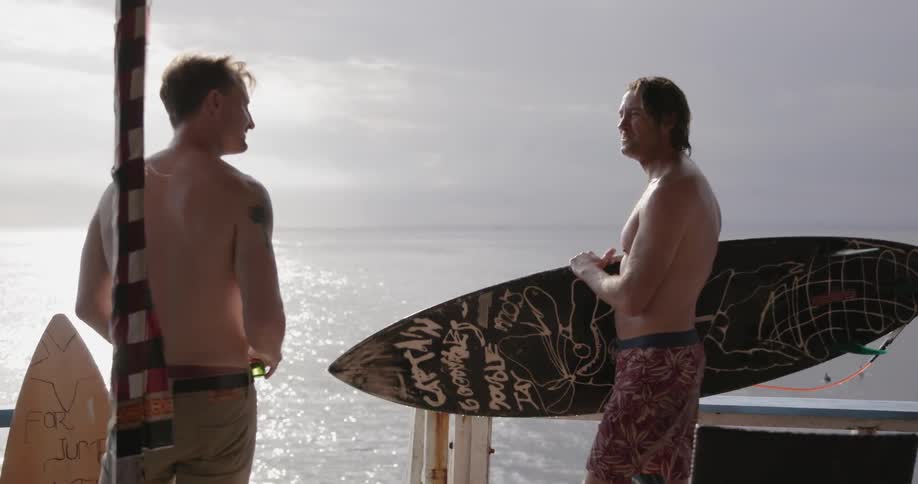 Two men talk on a pier