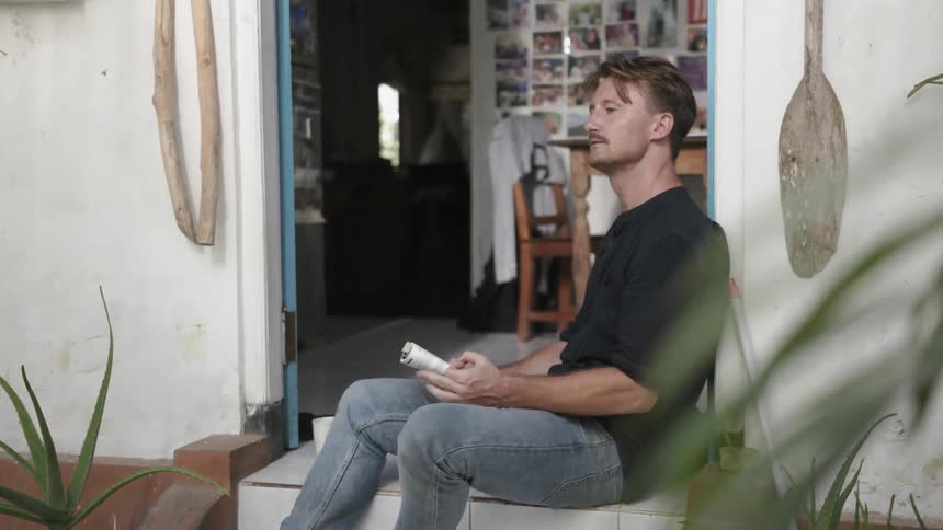 Man sits on front steps