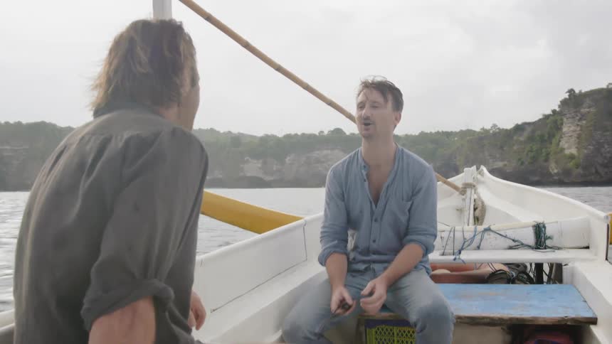 Two men ride on a boat together