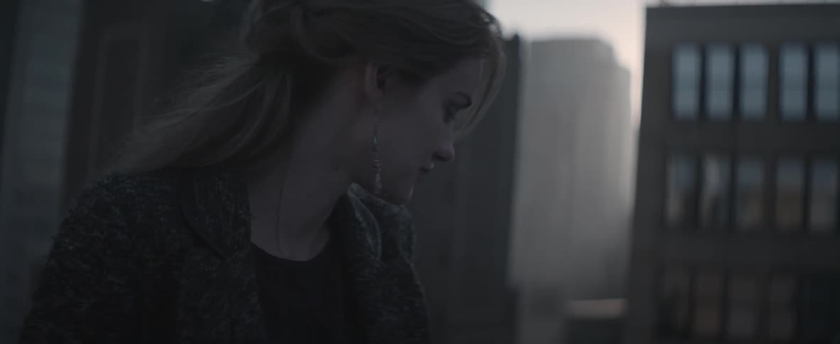 A woman standing outside talking with someone