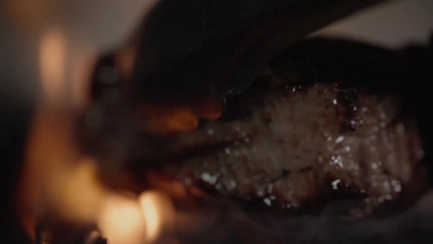 Steak is cooked on a grill