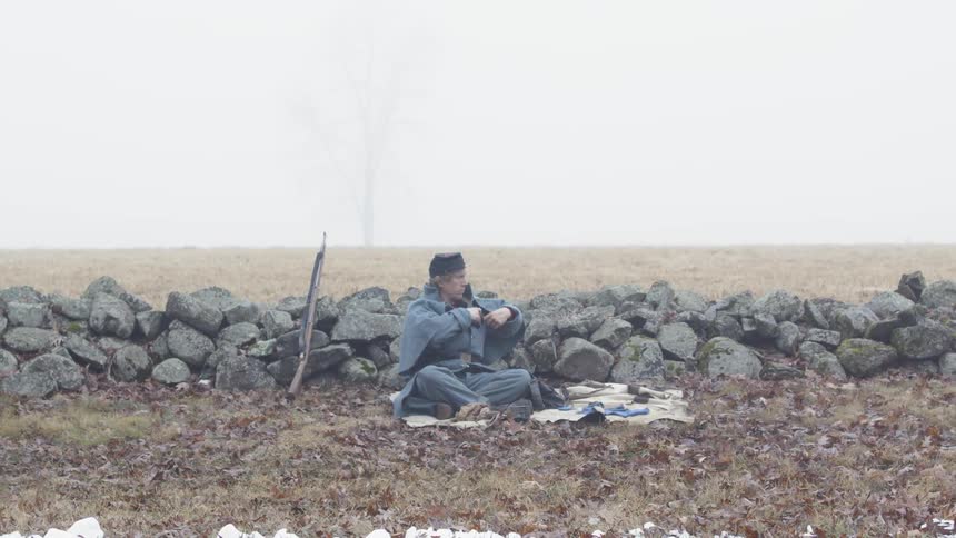 A soldier rests on the ground