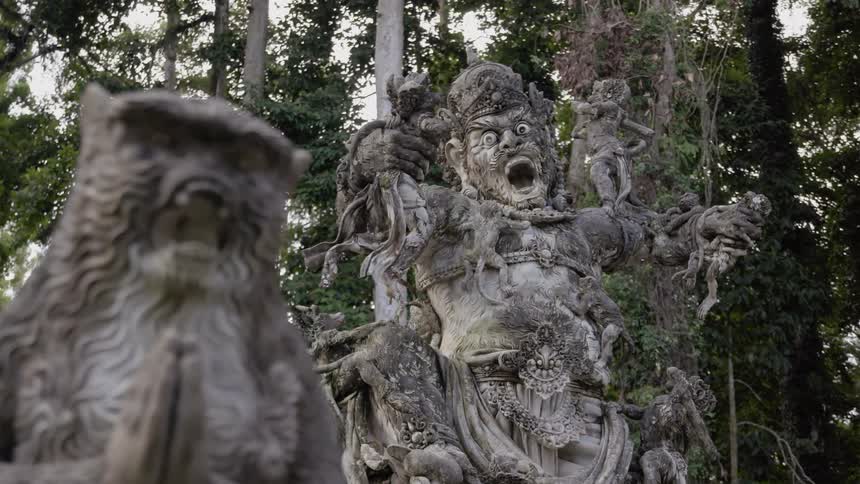 There are two wooden statues in the forest