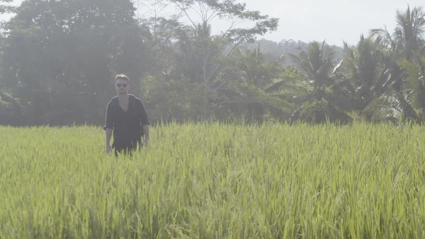 Man walks through a grassy field