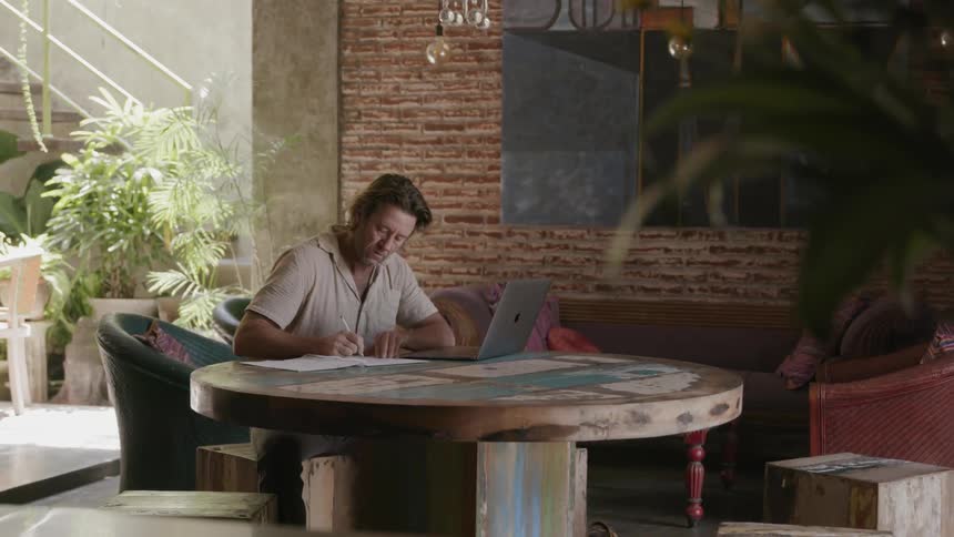 Man works on a laptop at a table