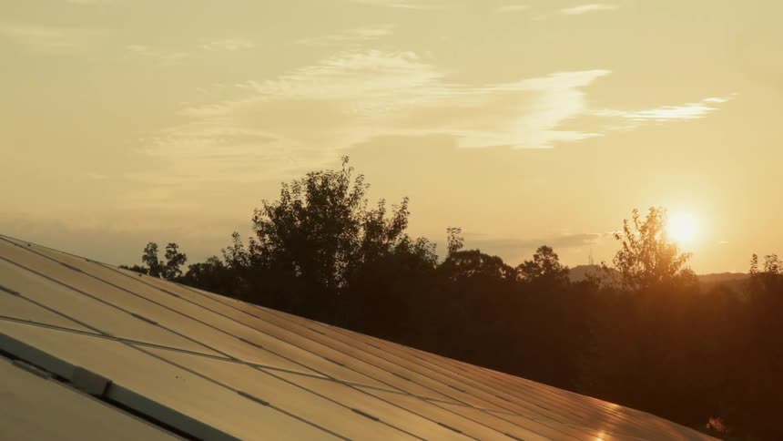 The sun sets over solar panels