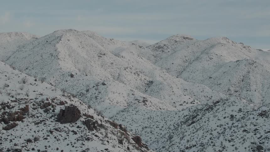 The mountain range is covered with heavy snow