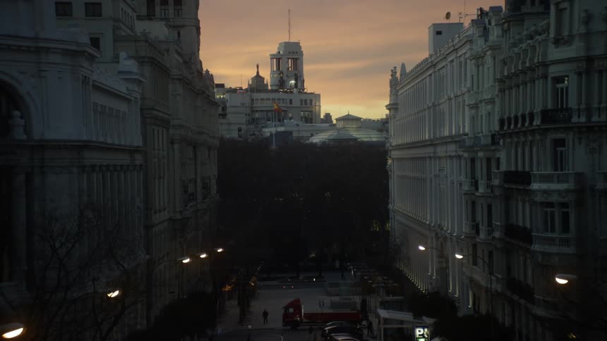 Buildings stand in a city at sunset