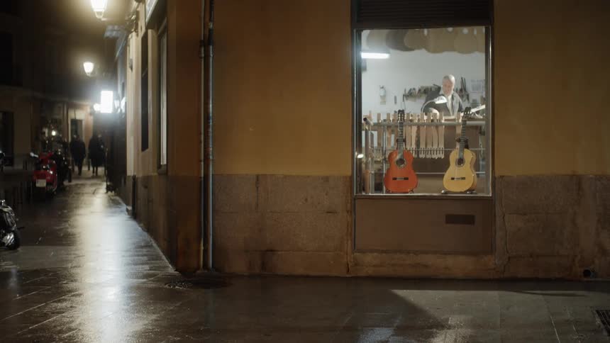 Guitars are on display in a storefront window