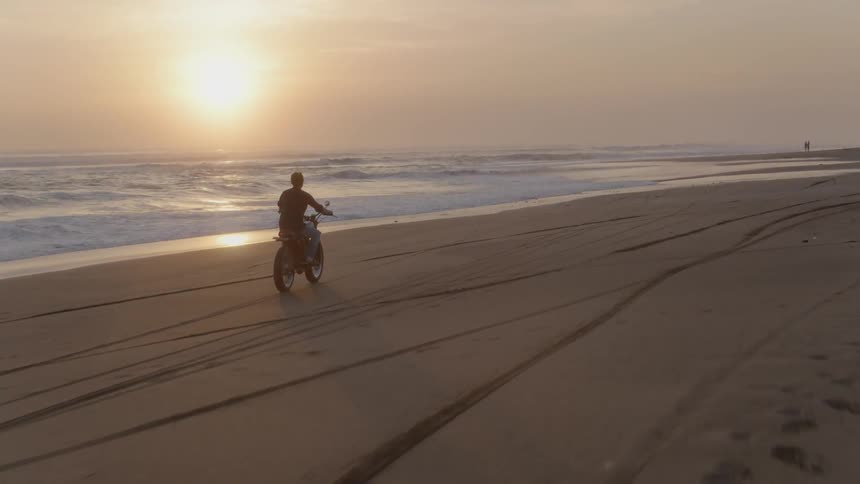 Man rides a motorcycle on the beach