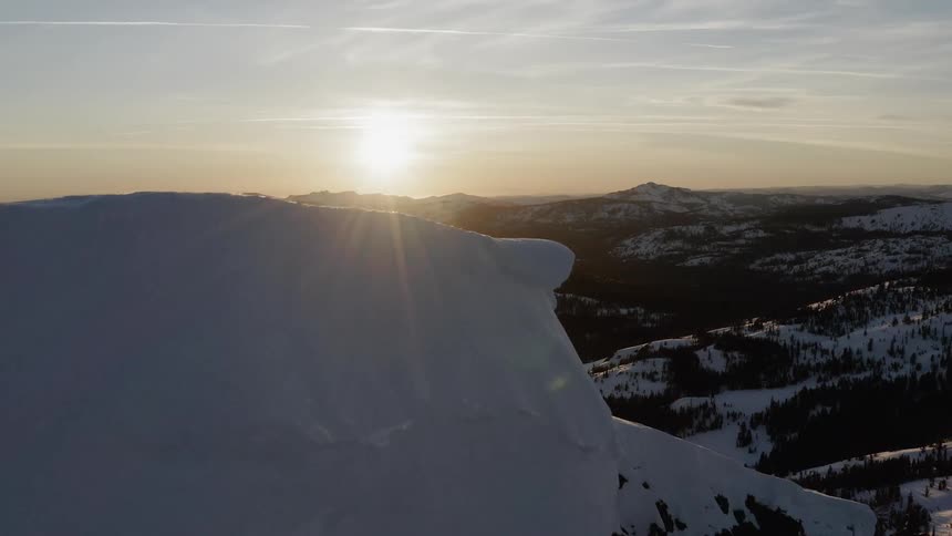 The sun is rising over snow-covered landscape