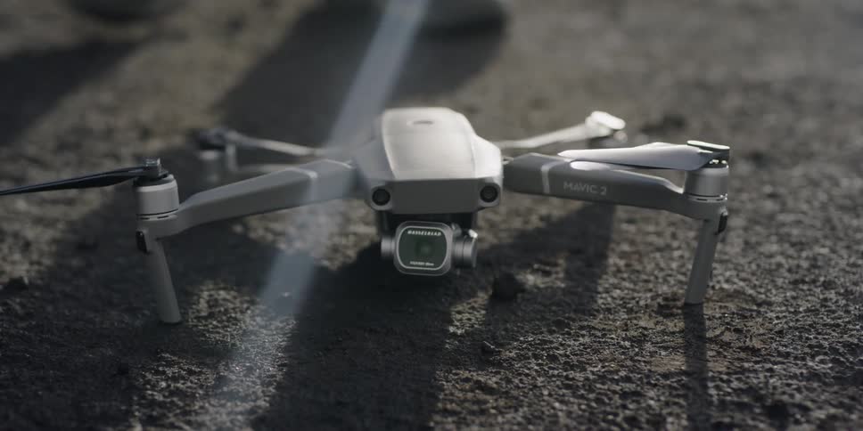 Finger presses a button on top of a drone
