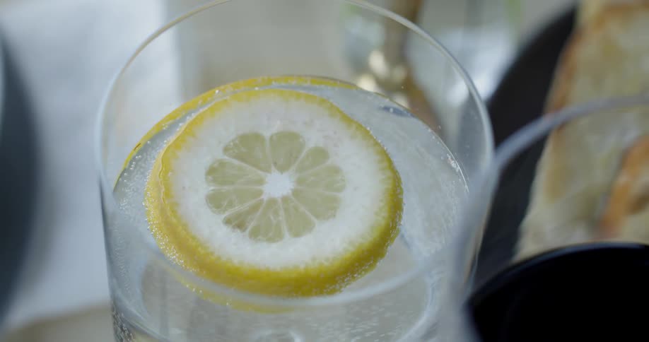 A lemon slice floats in a drink