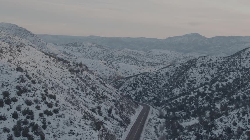 The road running through the mountain range is empty