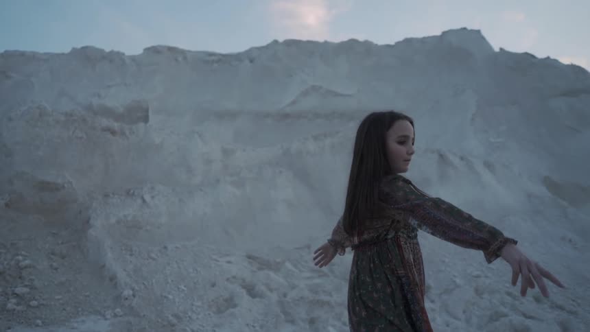 A young girl dances outside