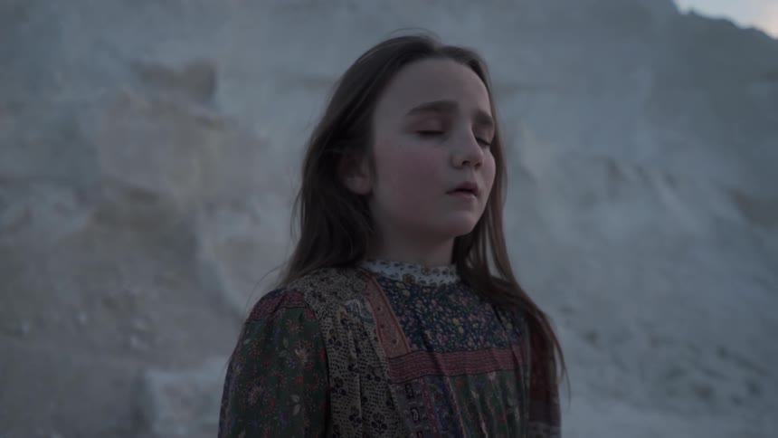 A child breathes heavy while standing by the hill