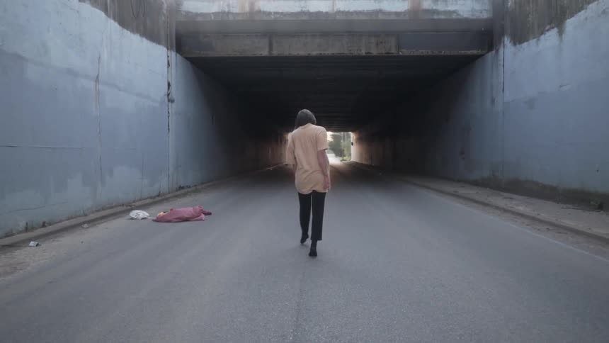 Woman does dance moves on an empty road