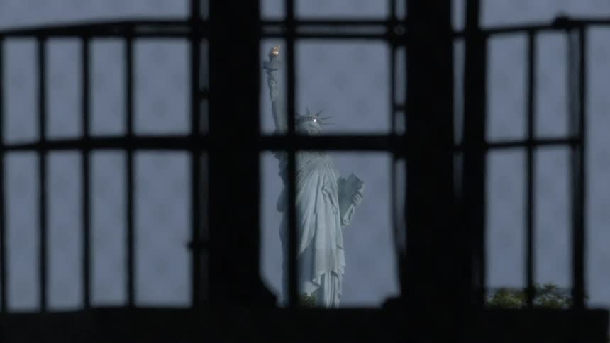 The statue of liberty is displayed outside of the window