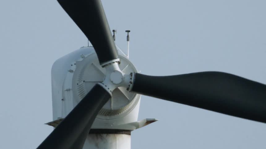 The windmill is slowly turning on a sunny day