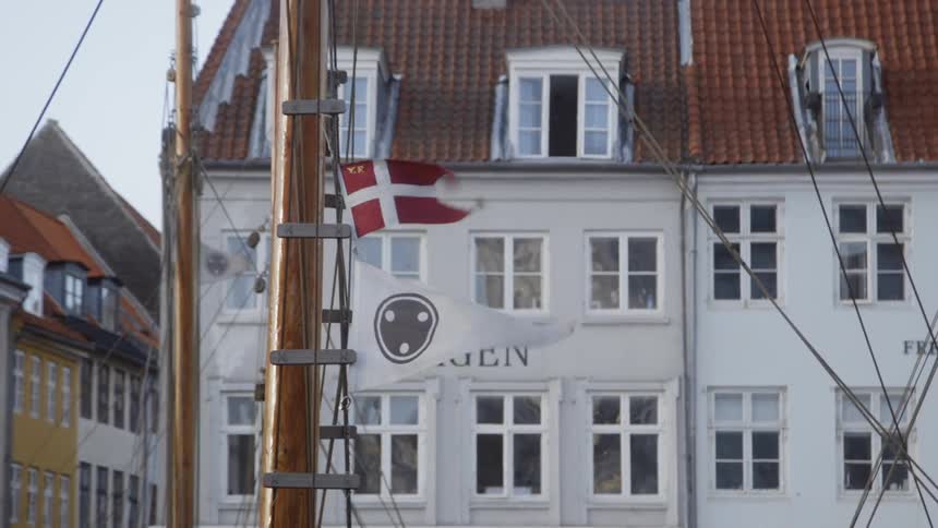 Flags billow on a ship mast