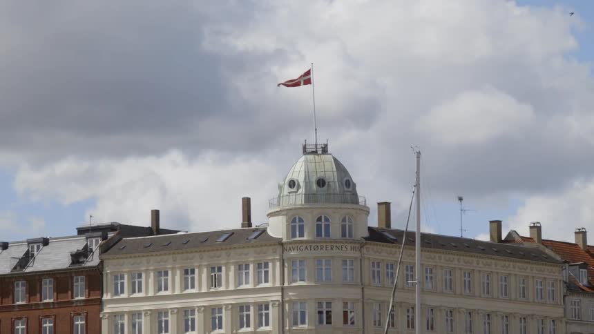 The flag is flying high above the building