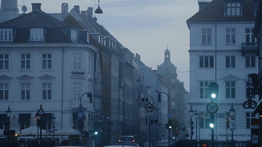 Car drives down a crowded city street