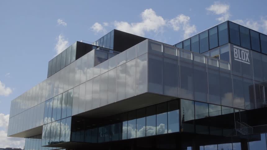 Clouds reflect on a glass building