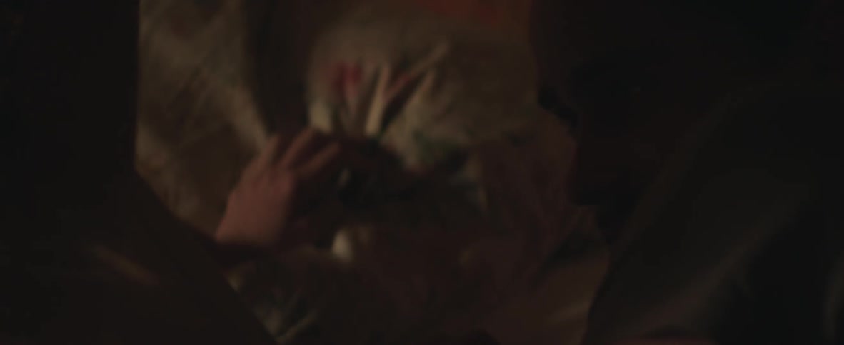 Two people rolling around in a bed