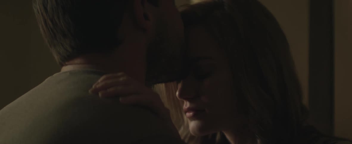 Man kisses a woman that looks sad