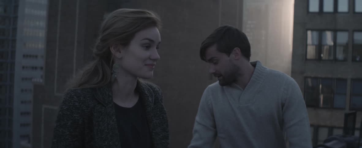Man and woman talk outside on a cloudy day