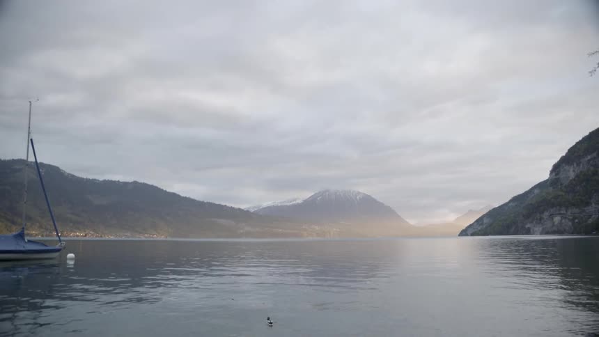 The lake has boats anchored near the shore