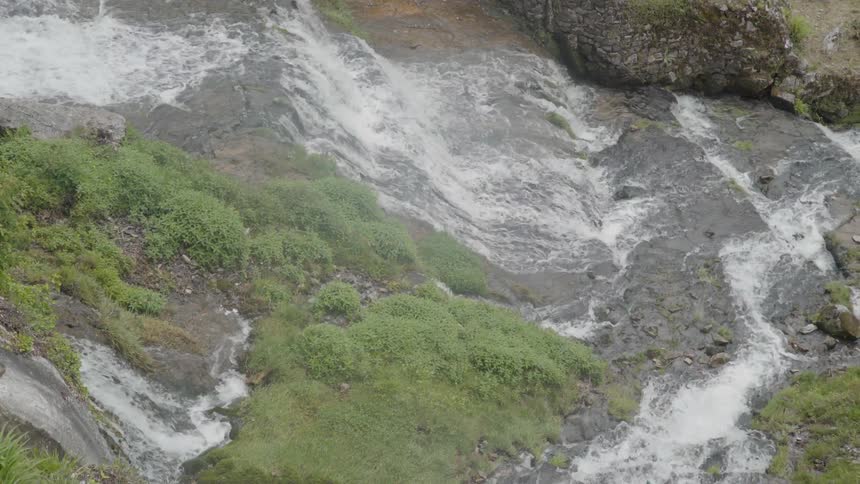 Water flowing down a cascade and going under a bridge