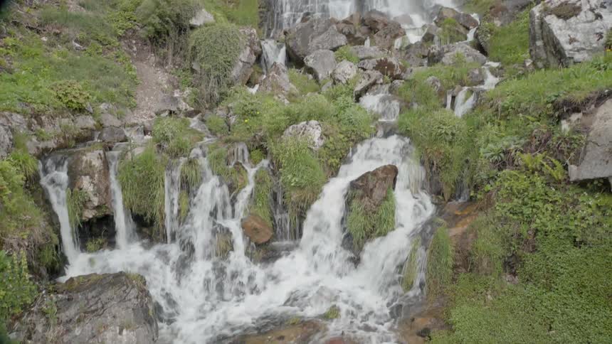 The waterfall pours down the rocks