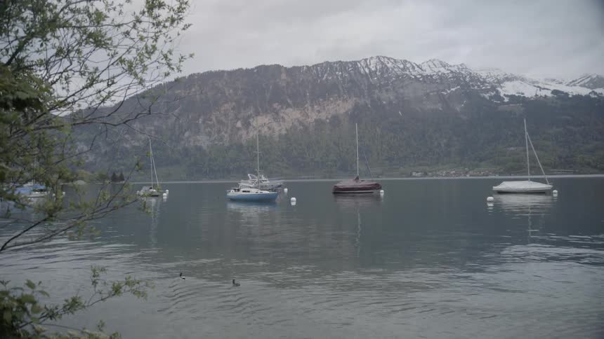 Boats sit in the calm lake waters
