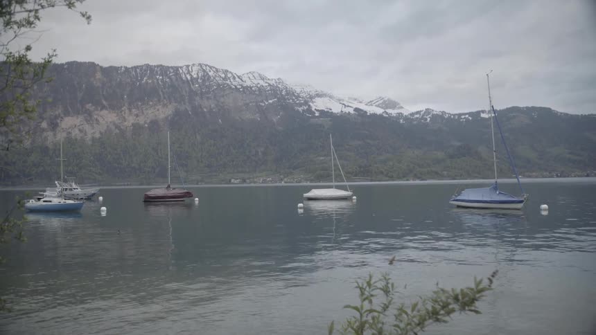 Boats float on a mountain lake