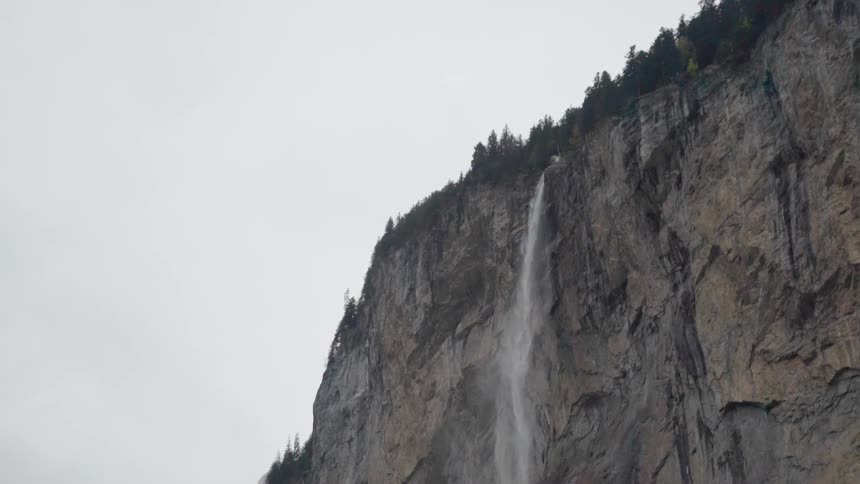A waterfall flows over a rocky cliff